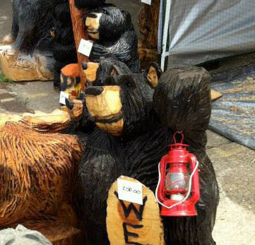 Standing Bear and Pug Peeking by Kerr Chainsaw Carving